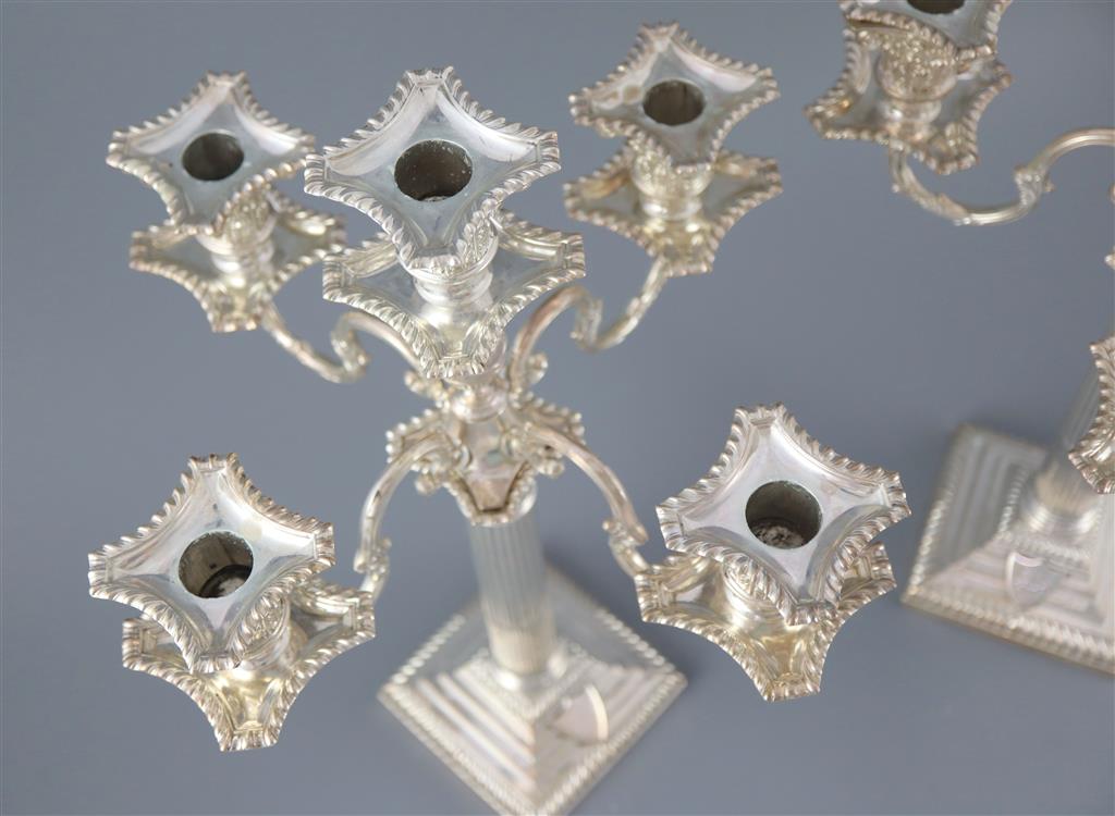A pair of late Victorian silver corinthian column four branch, five light candelabra by Carrington & Co,